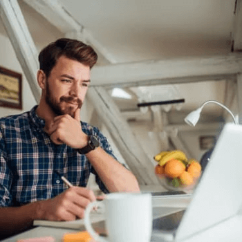 personal branding strategy, guy with computer in kitchen getting ready to write